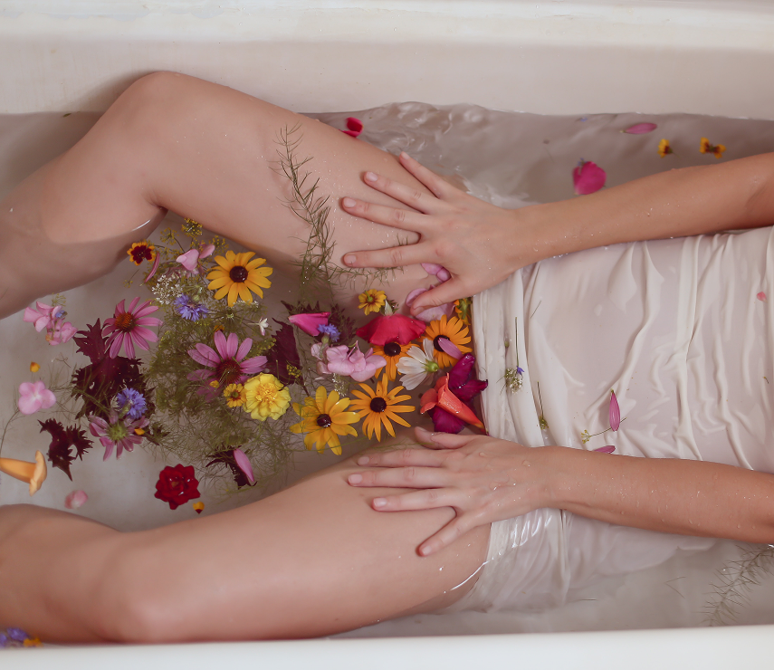Woman relaxing in a flower bath for natural wellness and skincare