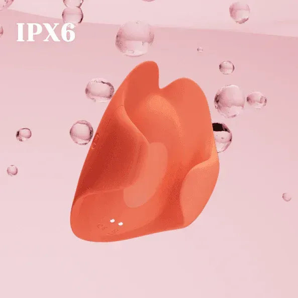 Orange silicone wearable mini vibrator with IPX6 water resistance on pink background