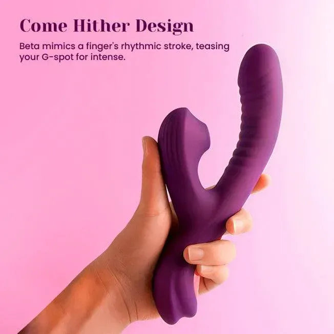 Purple silicone rabbit vibrator with swing shaft, hand-held on pink background