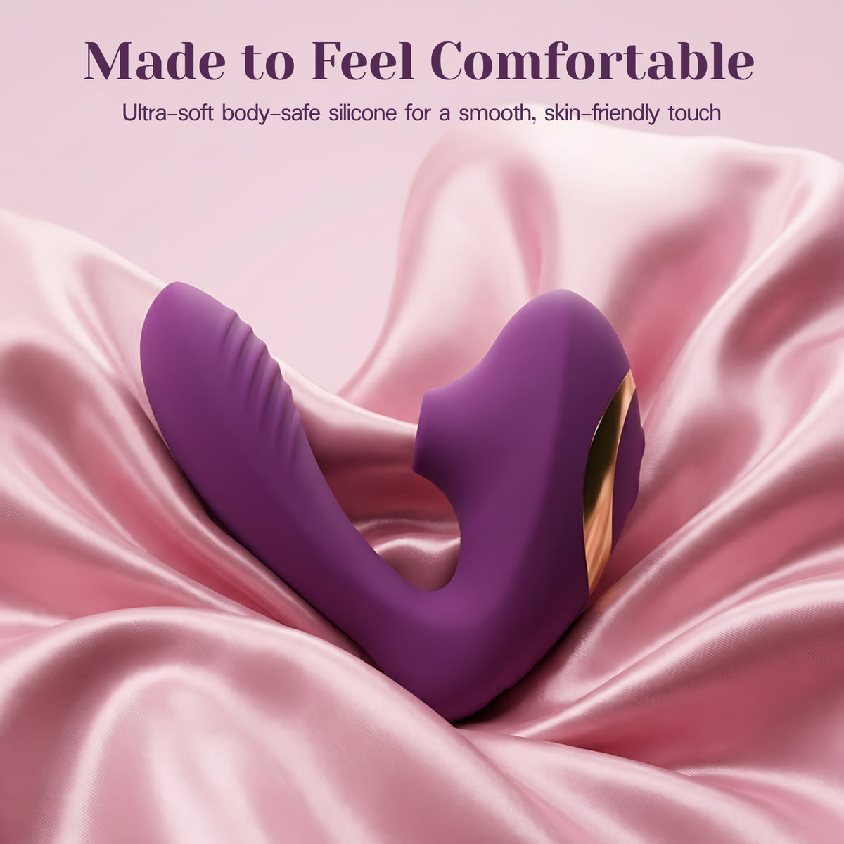 A purple silicone intimate massager with a gold accent, resting on draped pink satin fabric with promotional text at the top.