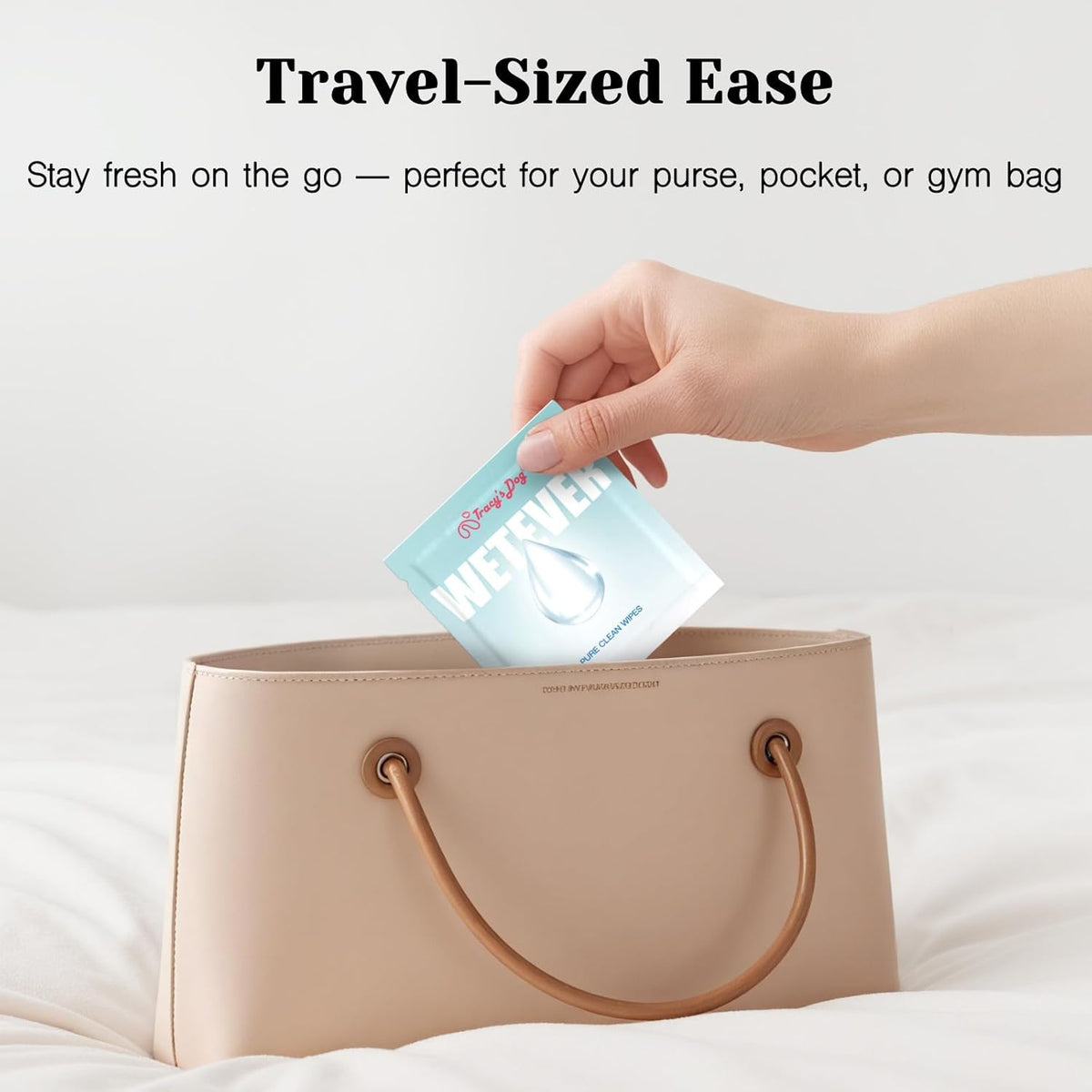 Individually wrapped Tracy's Dog Pure Clean Wipes in a purse for travel-sized freshness
