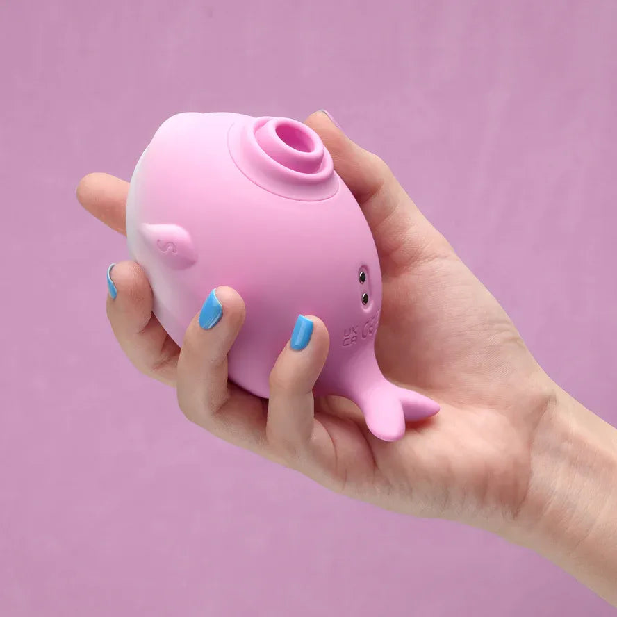 Pink whale-shaped clitoral sucker with silicone body and suction nozzle