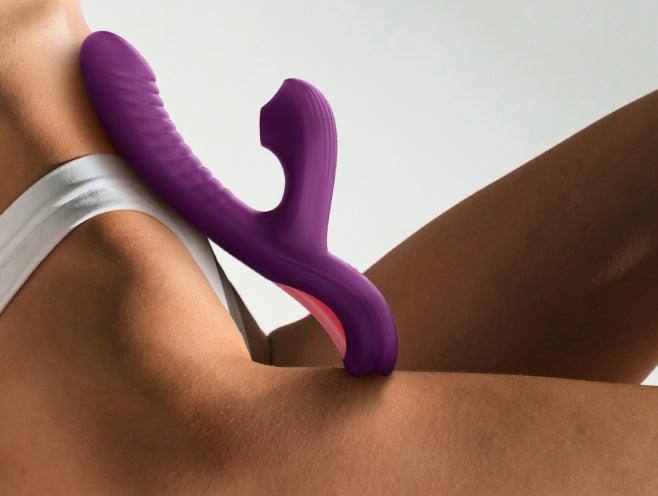 Purple silicone rabbit vibrator with suction tip and G-spot curve on skin