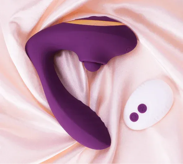 Purple clitoral tapping vibrator with white remote on soft satin
