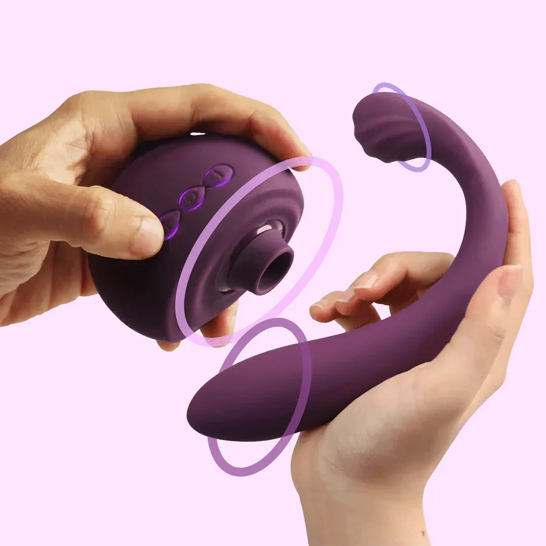 Purple flexible clitoral sucking vibrator with curved shaft, shown in hand